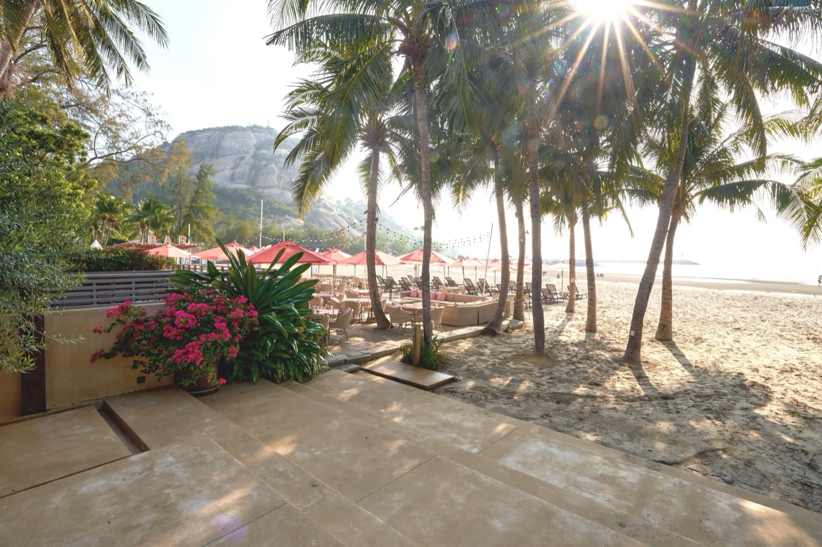 Palm-shaded beachfront terrace and sand at Anantasila Beach Resort near Khao Takiab
