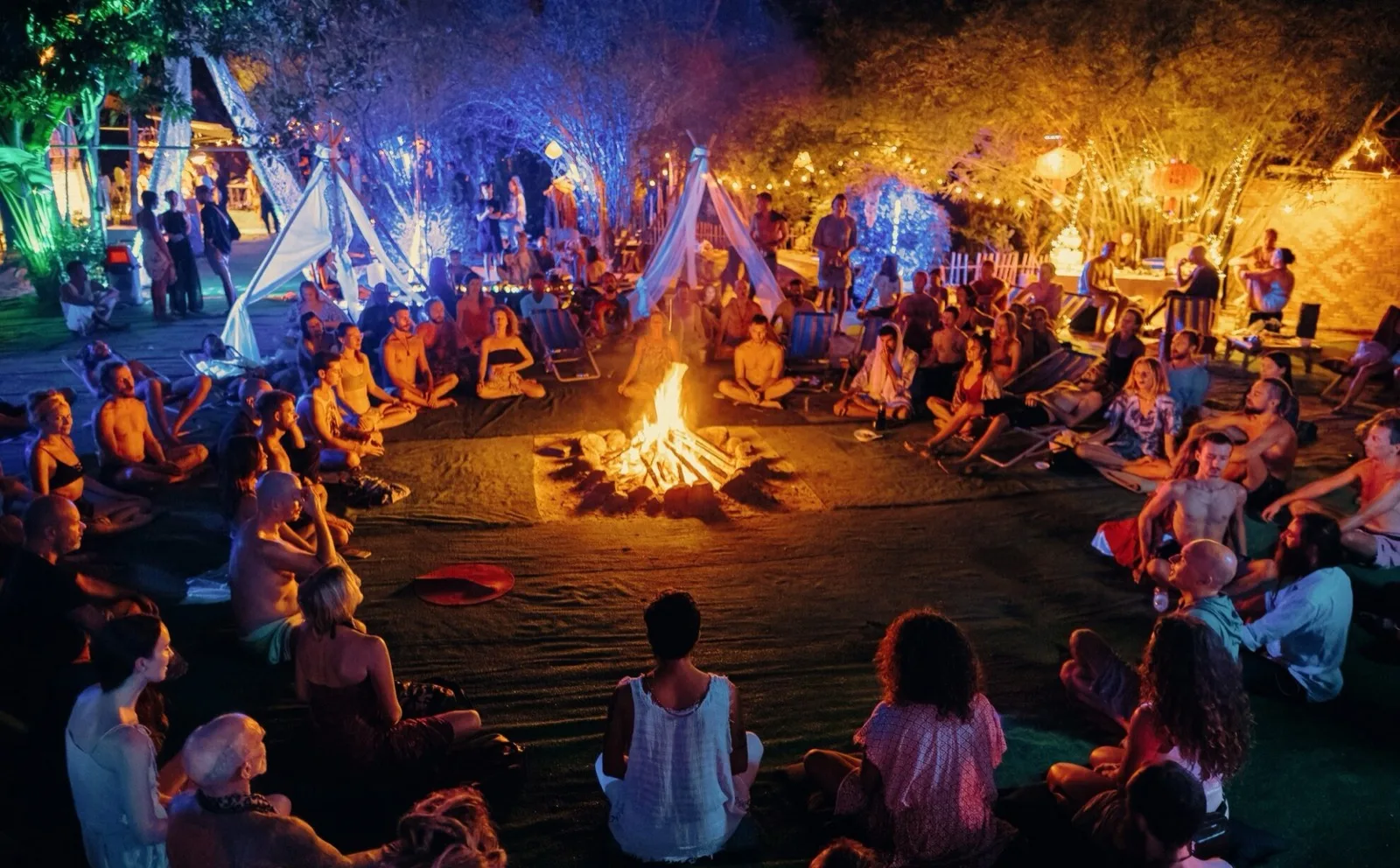 Guests sitting around the evening fire circle at AUM Phangan