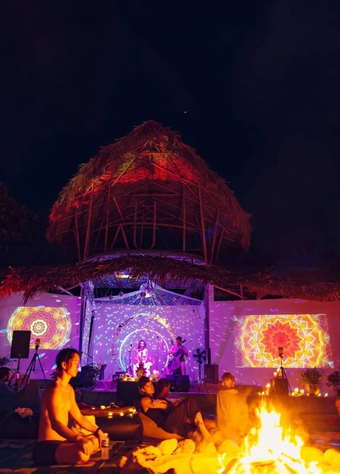 Illuminated dome and fire at night at AUM Phangan in the jungle
