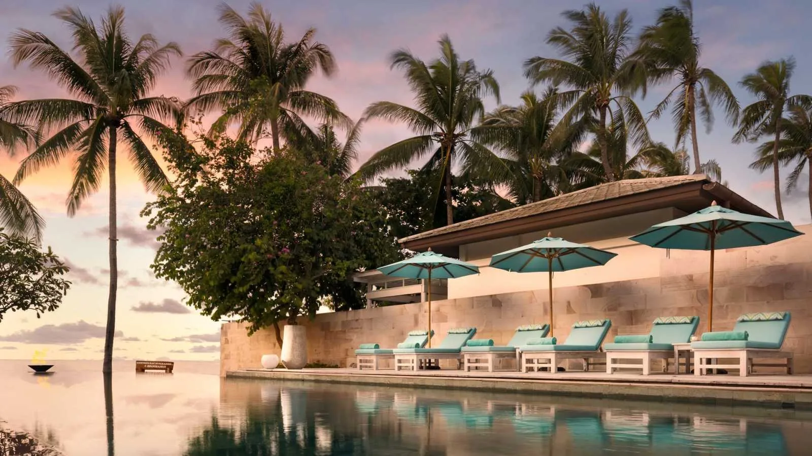 Beachfront pool at Avani+ Vacation Club Samui with sun loungers facing the bay at Phang Ka