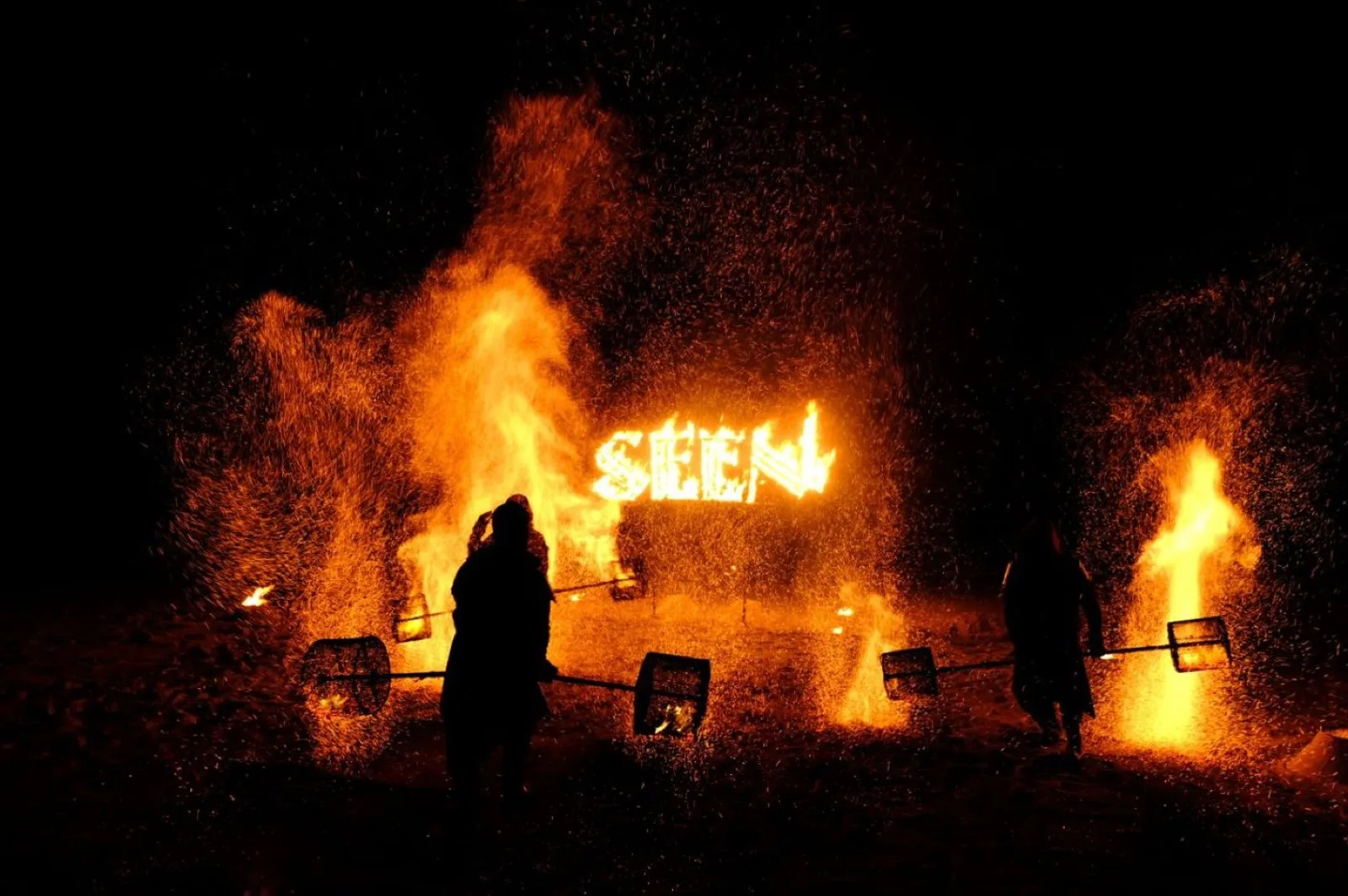 Night fire show with the illuminated SEEN sign at CLUB SEEN Koh Samui