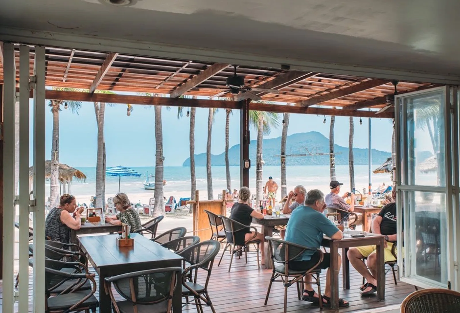 Open-air restaurant facing the beach and mountains at Dolphin Bay Resort