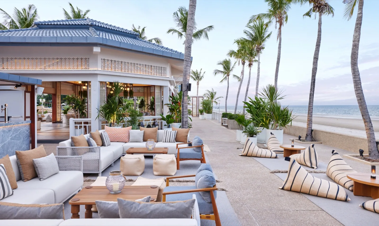 Nómada beach club lounge seating facing the sea at Dusit Thani Hua Hin
