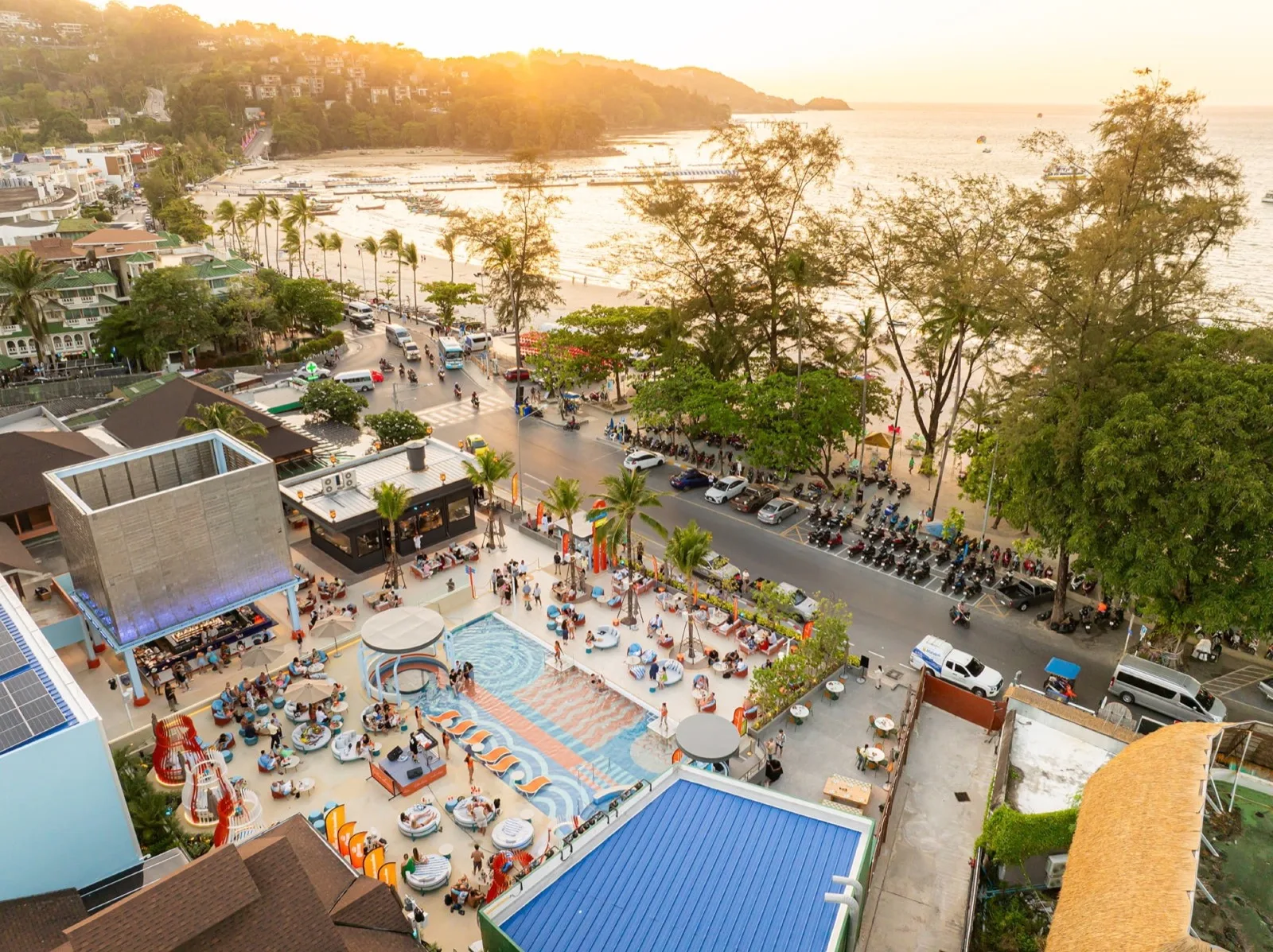 Aerial view of Endless Summer Beach Club infinity pool and Patong Beach at sunset, Phuket
