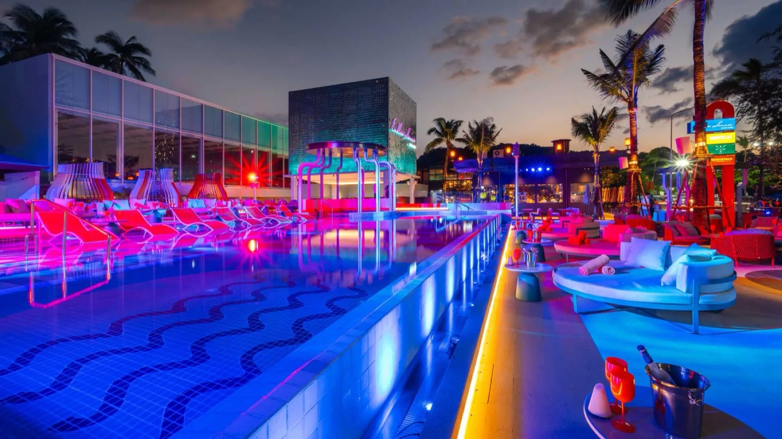 Endless Summer Beach Club infinity pool lit up in blue and red at dusk, Patong