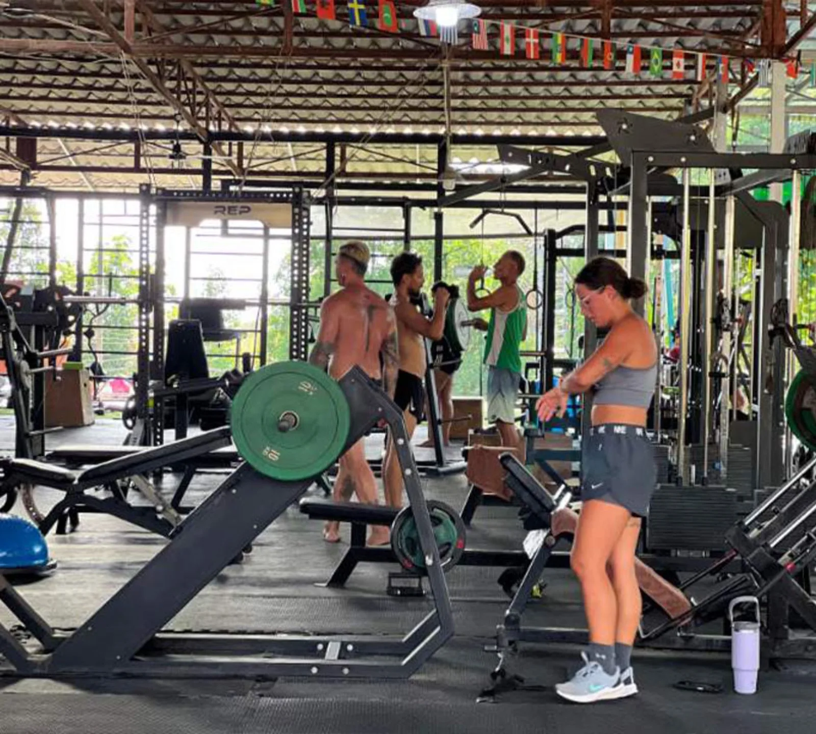 Members training with free weights and racks at Evolve Health Club, Koh Phangan