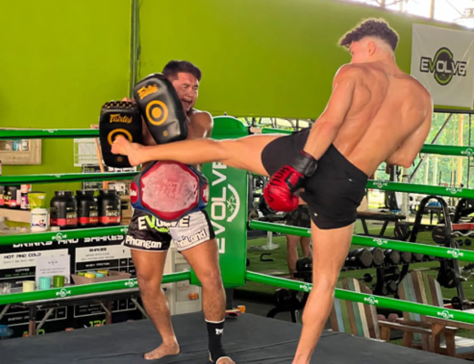 Muay Thai pad session in the ring at Evolve Health Club