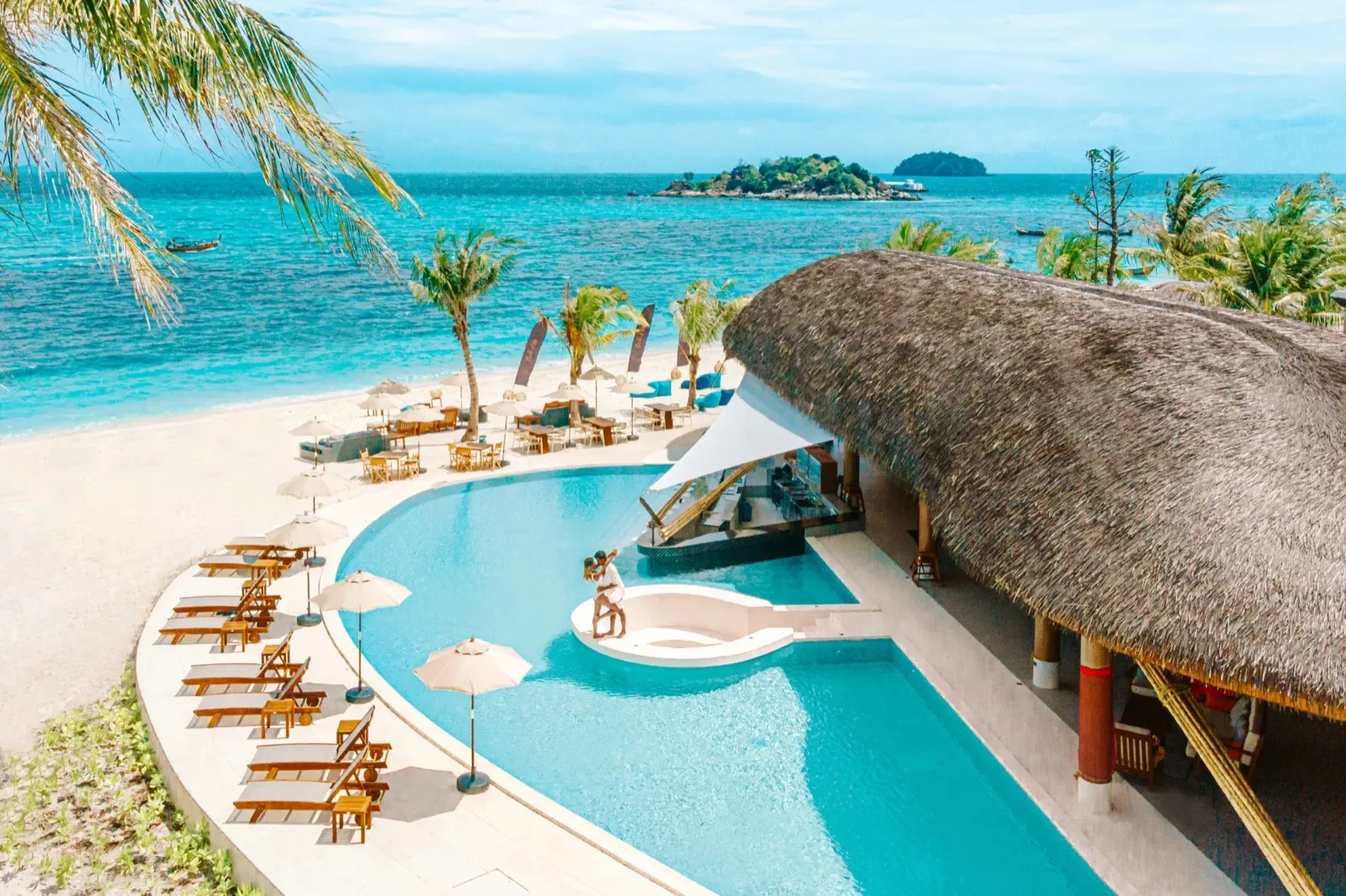Aerial view of the beachfront pool, thatched pool bar and loungers at SOL Beach Lounge, Irene Resort Koh Lipe