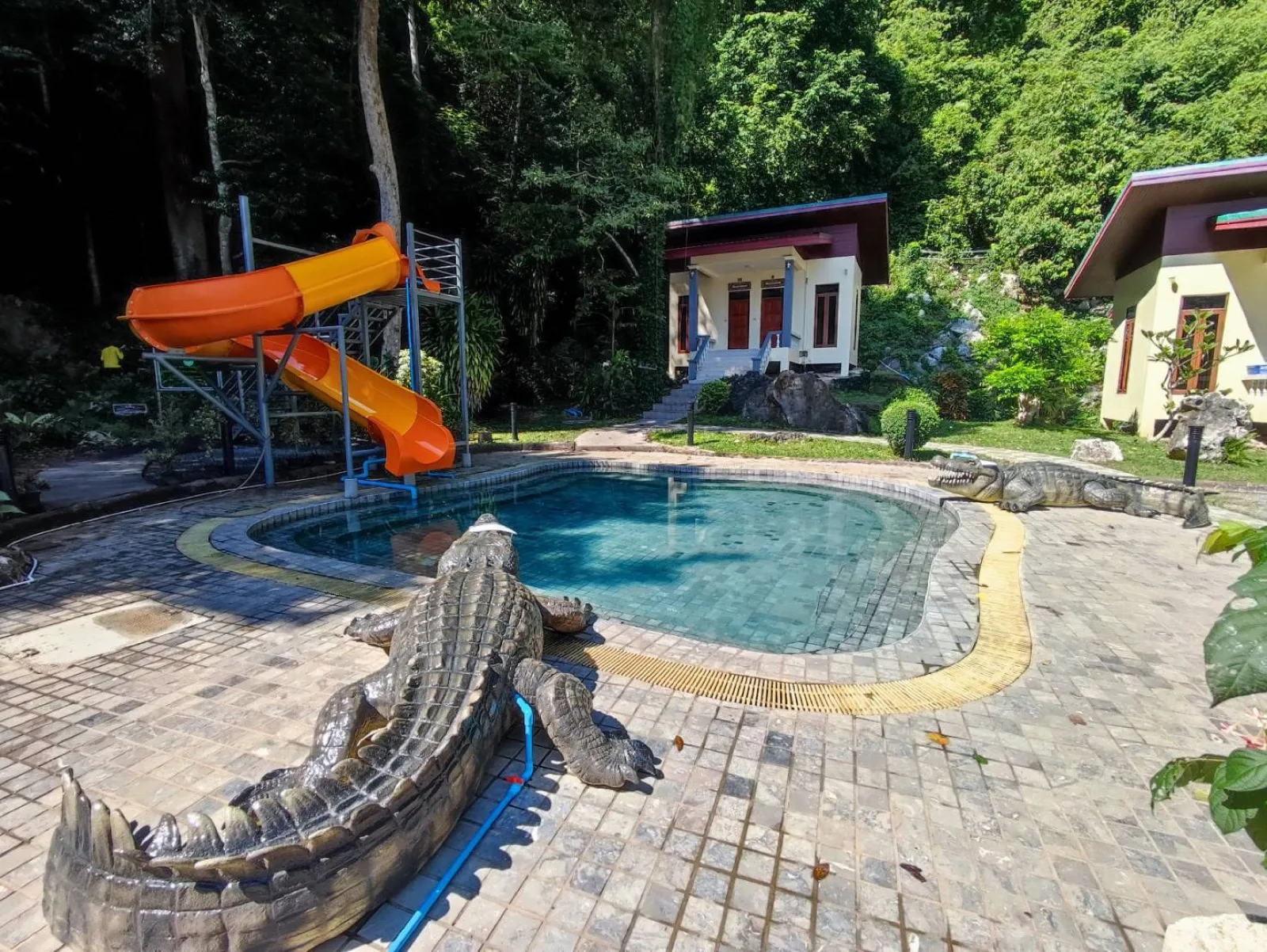 Hot spring pool, slide and pavilions at Khao Chaison Hot Spring in Phatthalung