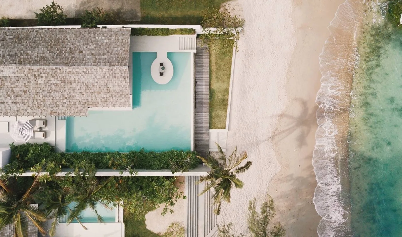 Aerial view of a beachfront pool villa and Choeng Mon Beach at Kimpton Kitalay Samui