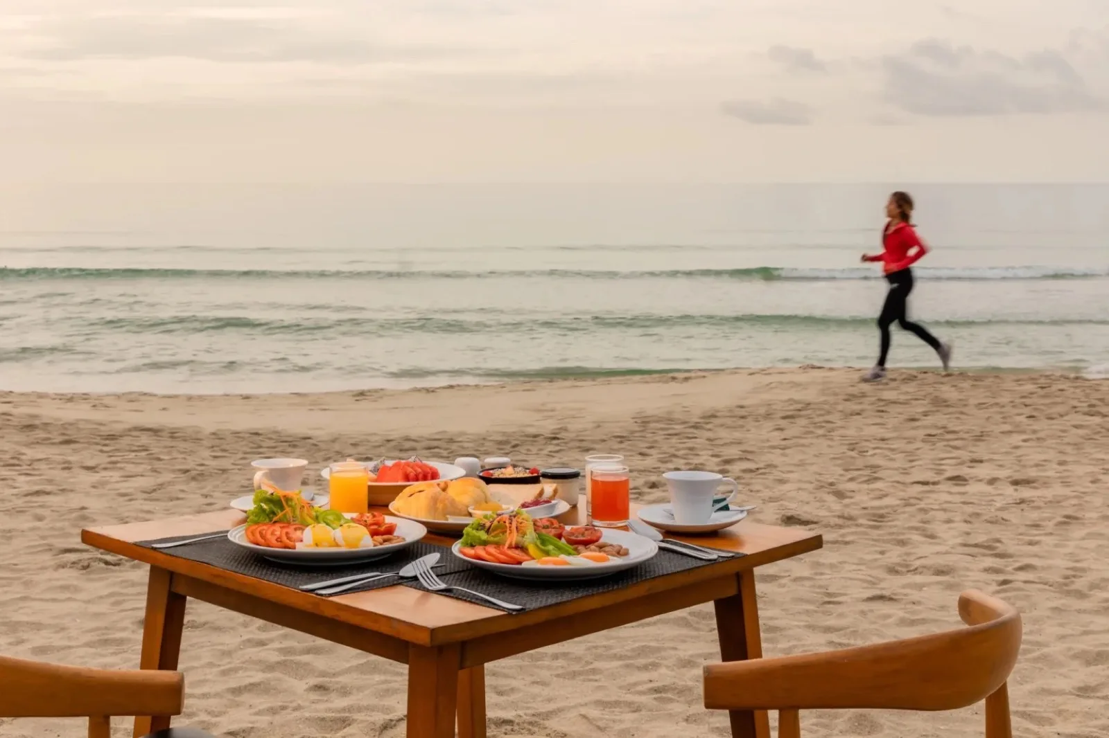 Breakfast table on the sand facing the sea at Malibu Beach Resort Samui
