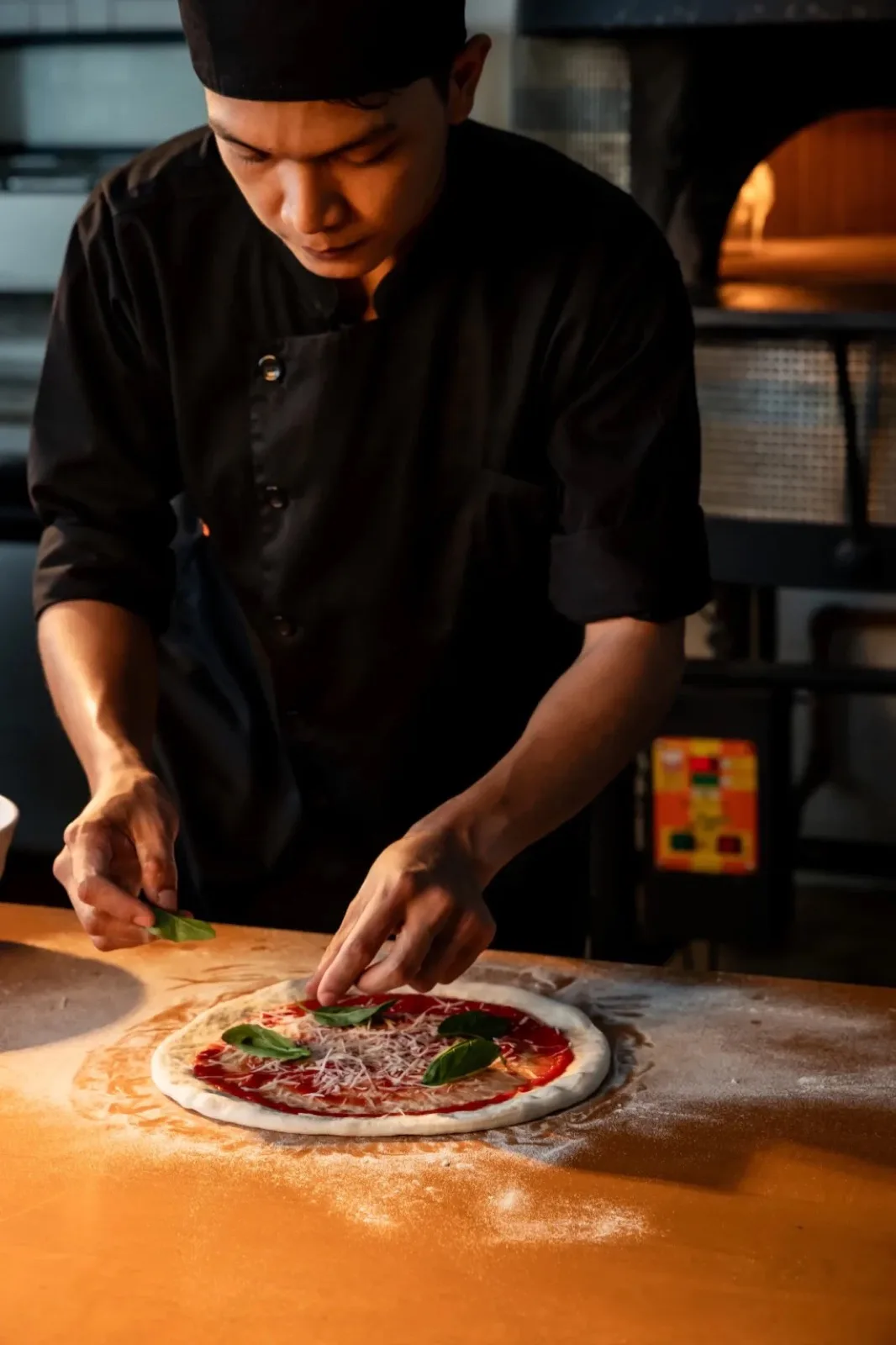 Chef preparing a Neapolitan pizza at Marzano Pizzeria, Malibu Beach Resort Samui