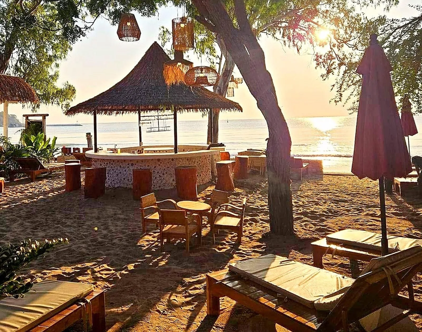 Thatched beach bar at sunrise at Mama Daeng Beach Sauna in Hua Hin