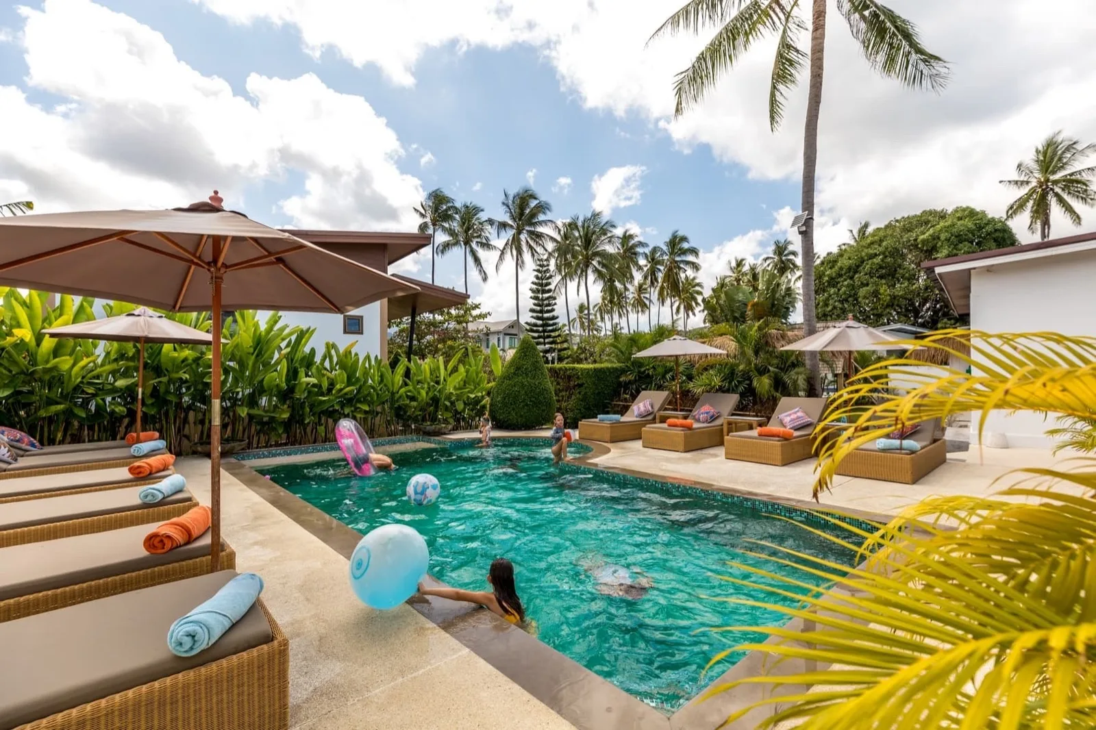 Families swimming in the garden pool at Maya Resort Samui