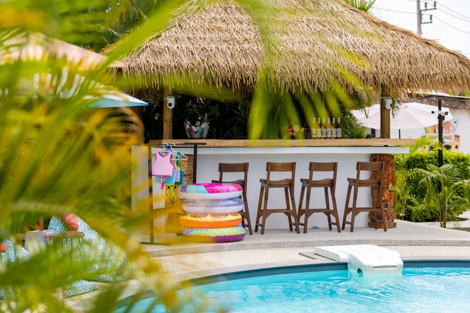 Thatched pool bar with stools beside the pool at Maya Resort Samui