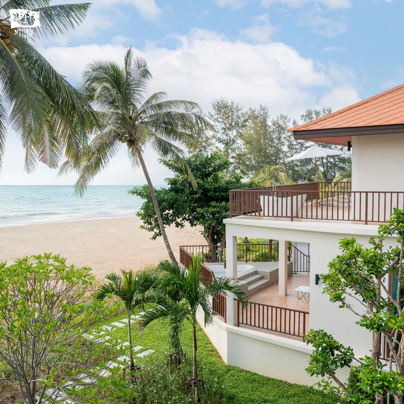 Beachfront villa and palms at Natural Beach Resort on the Tha Sala coast