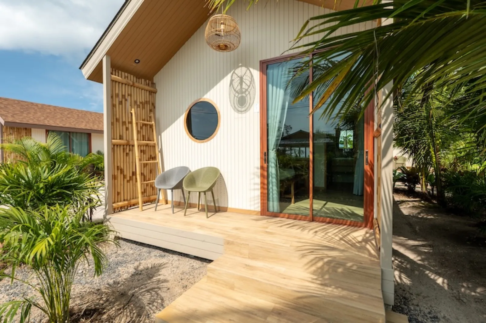 Wooden terrace and sliding doors of a bungalow at Orion Healing Centre, Koh Phangan