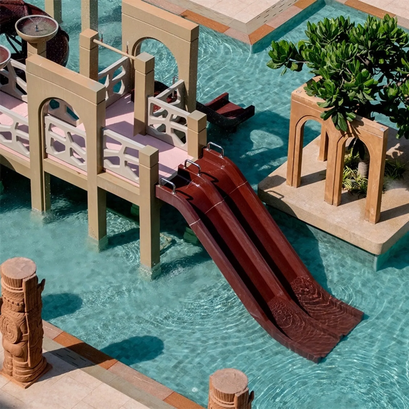 Twin water slides between carved Mesopotamian-style arches at Pamookkoo Resort