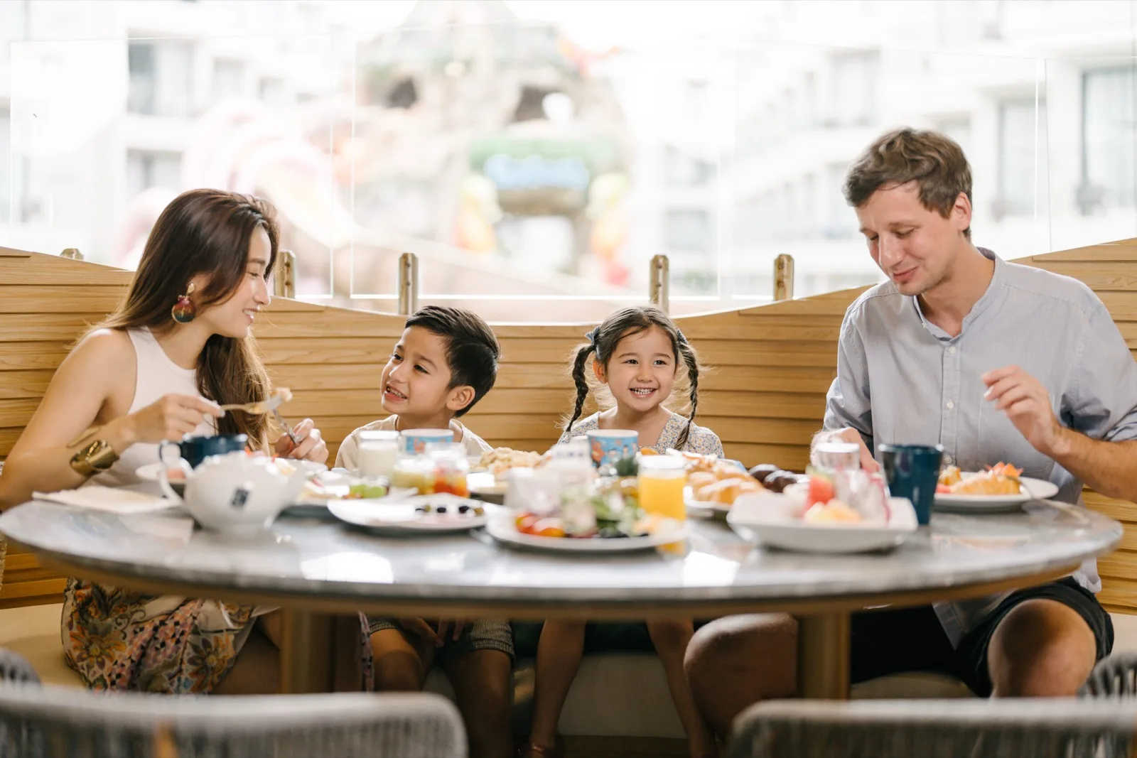 Family dining by the pool at Phuket Emerald Beach Resort, Karon