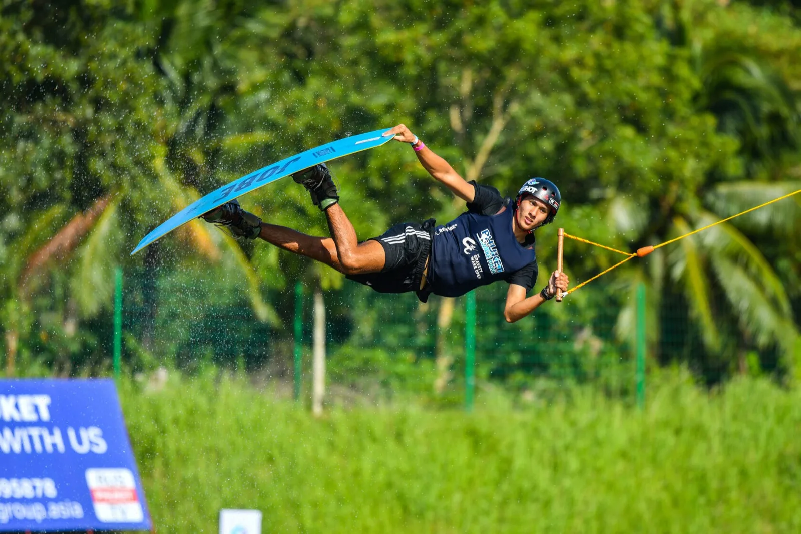 Rider performing an aerial trick on the big cable at Phuket Wake Park in Kathu