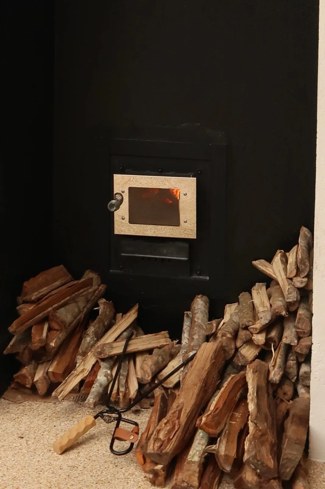 Stacked firewood beside the stove that heats the sauna at Recovery Club Koh Tao