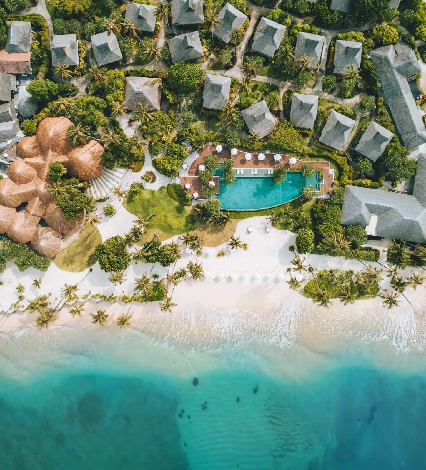 Drone view of SAii Phi Phi Island Village showing the pool, bungalows and beachfront
