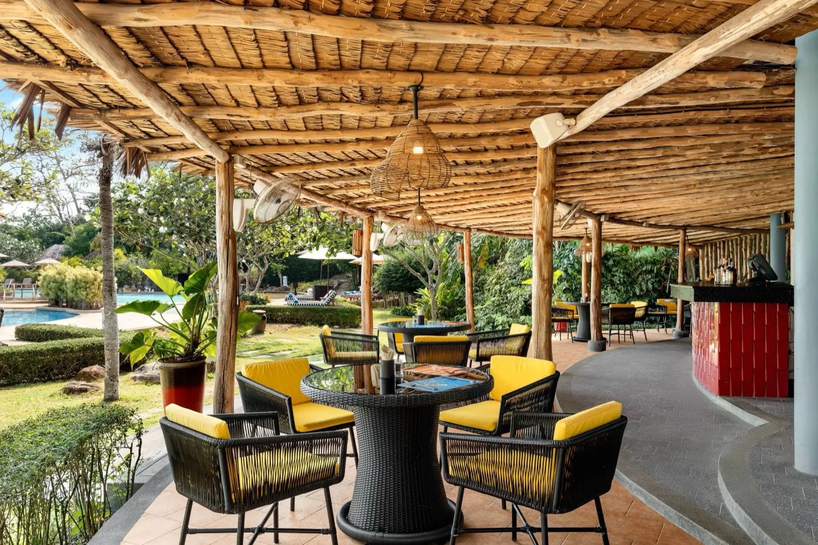 Shaded open-air restaurant terrace with rattan chairs at SAii Phi Phi Island Village