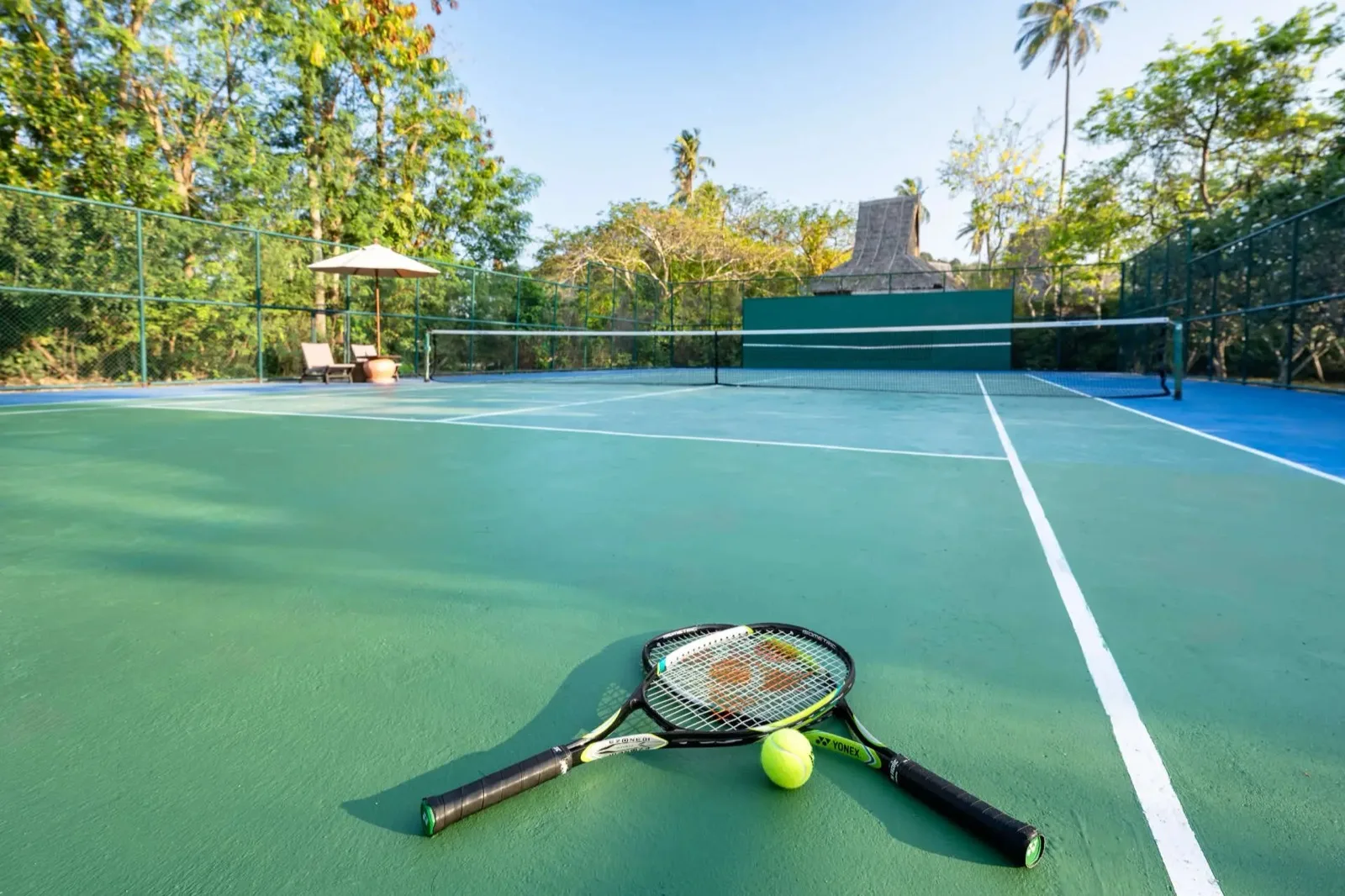 Tennis court set in tropical gardens at SAii Phi Phi Island Village, Koh Phi Phi