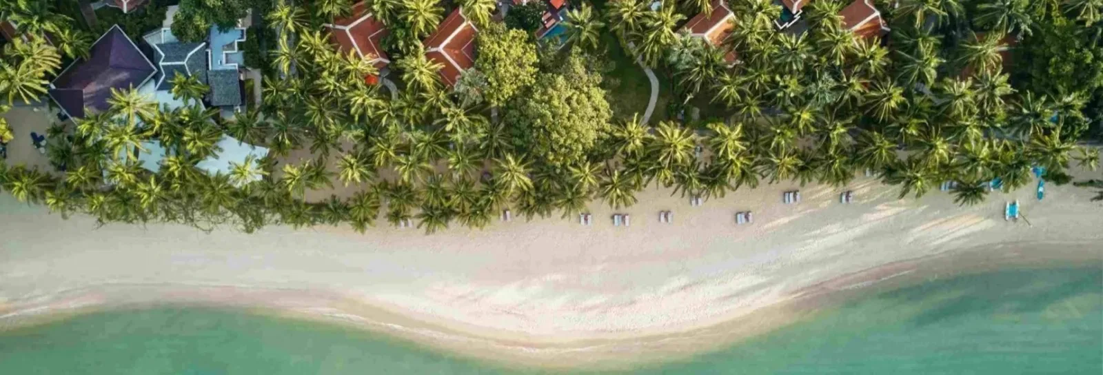 Aerial view of Santiburi Koh Samui gardens and Maenam Beach