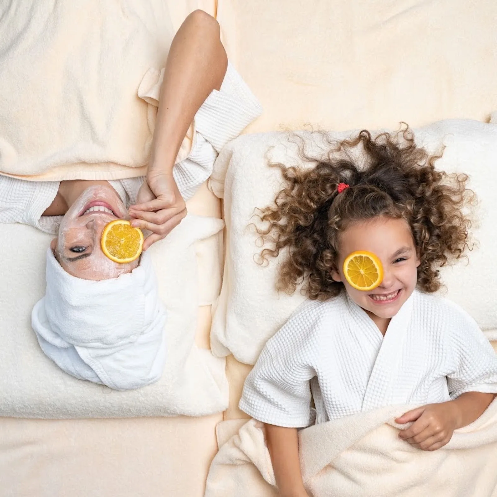 Mother and child relaxing with orange slices at Santiburi Spa, Koh Samui