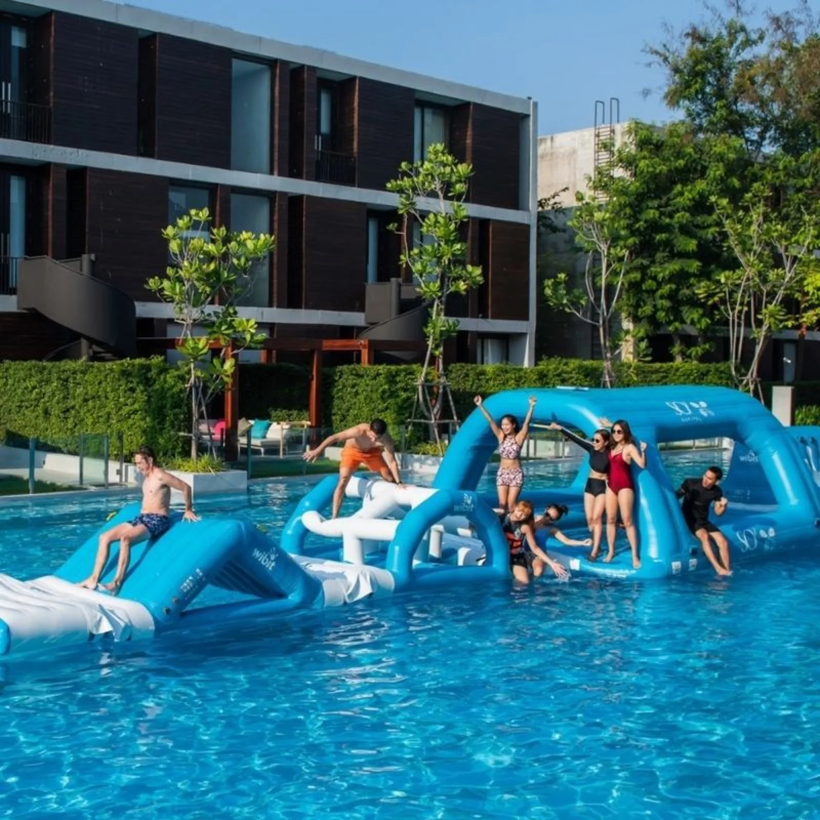Guests on the Wibit inflatable obstacle course in the Signature Pool at SO/ Sofitel Hua Hin