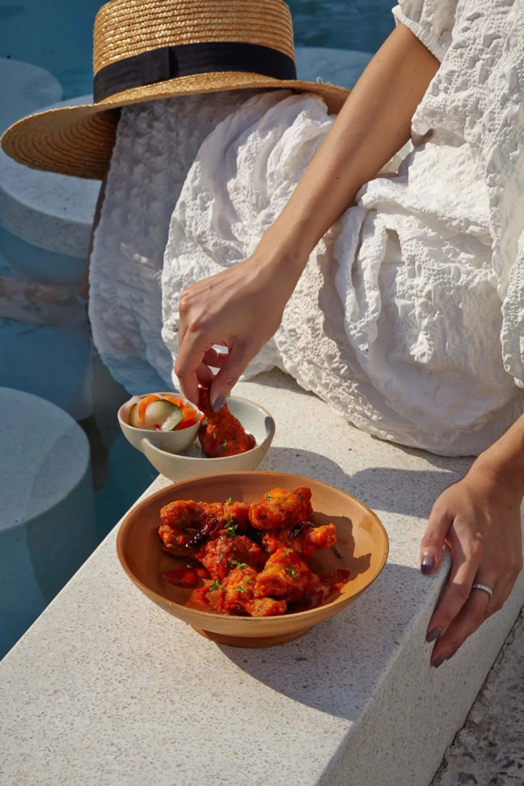 Guest enjoying a Thai seafood snack by the pool at Sundance Dayclub