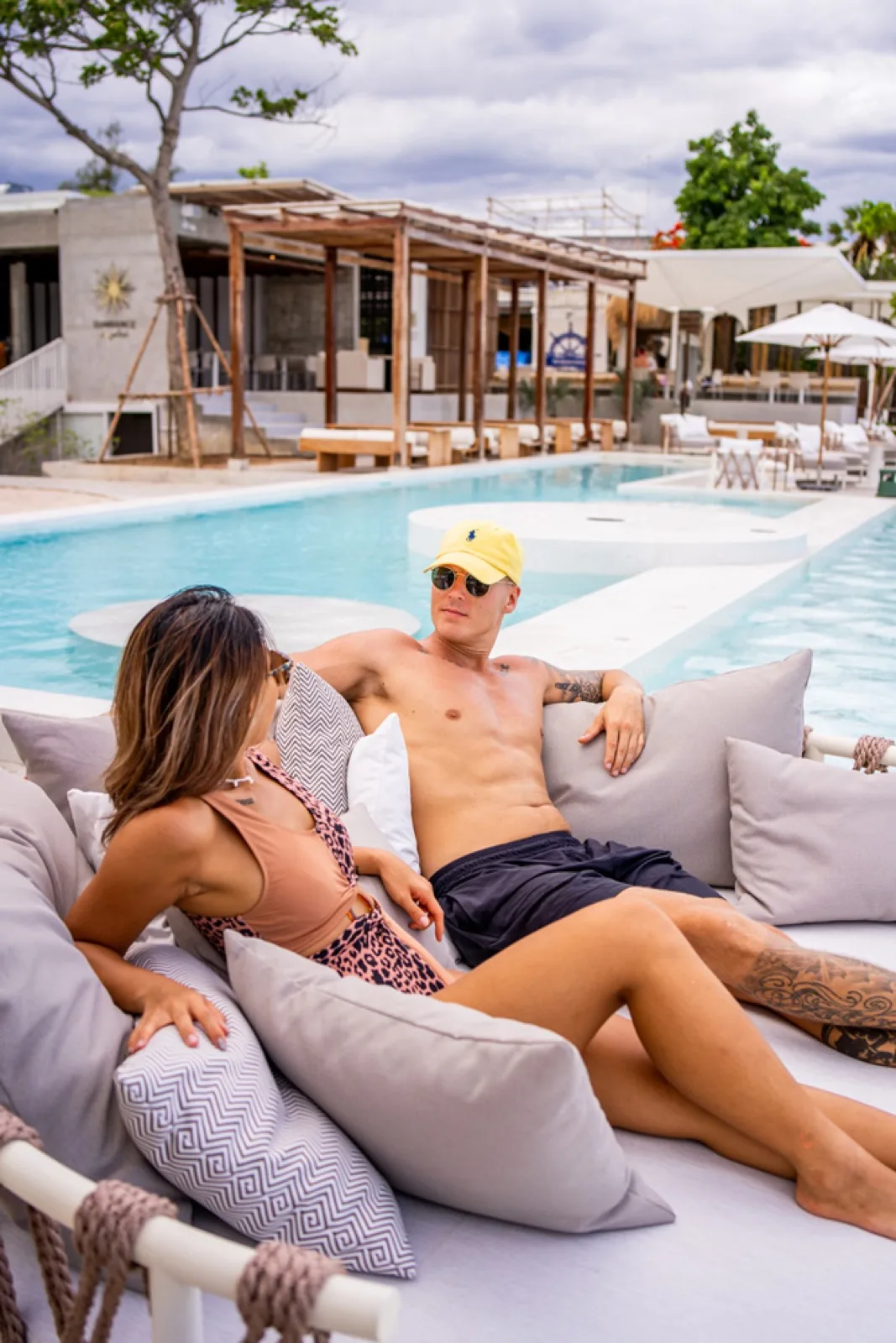 Couple relaxing on a poolside daybed at Sundance Dayclub in Hua Hin