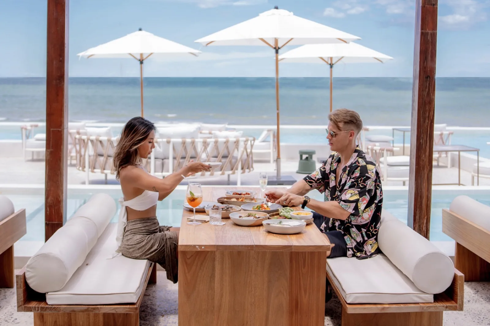 Couple dining at a beachfront sala table at Sundance Dayclub with sea views