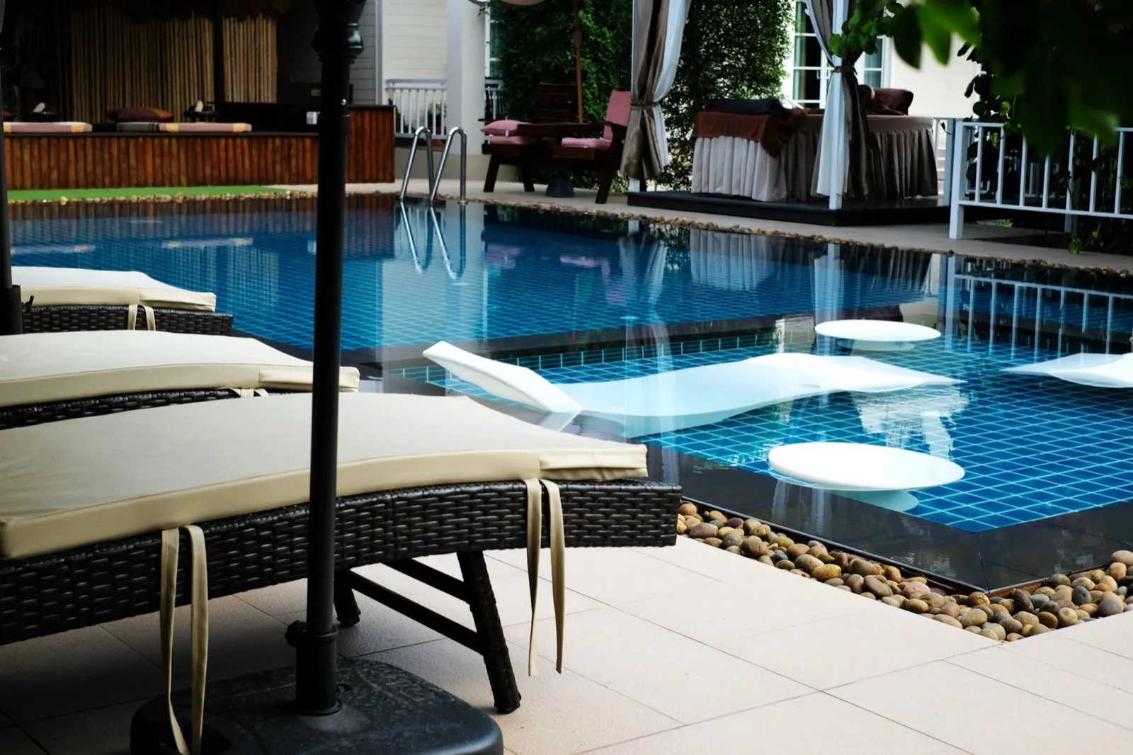 Outdoor pool with sun loungers and in-water loungers at The Cottage Retreat Hua Hin