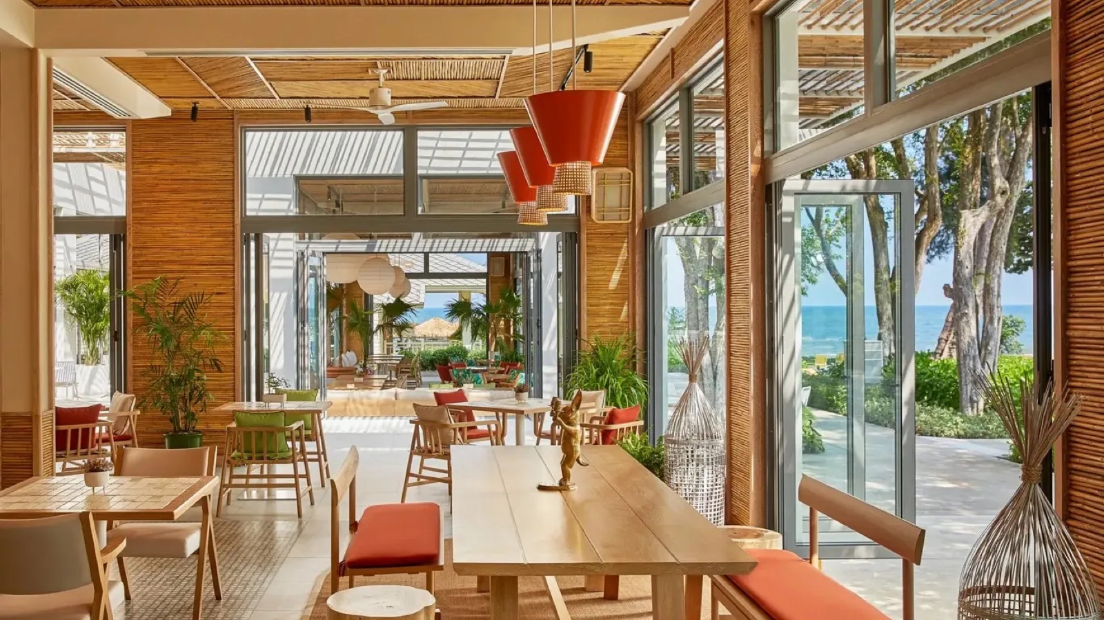 Lido restaurant interior with timber walls and sea glimpses at The Standard Hua Hin