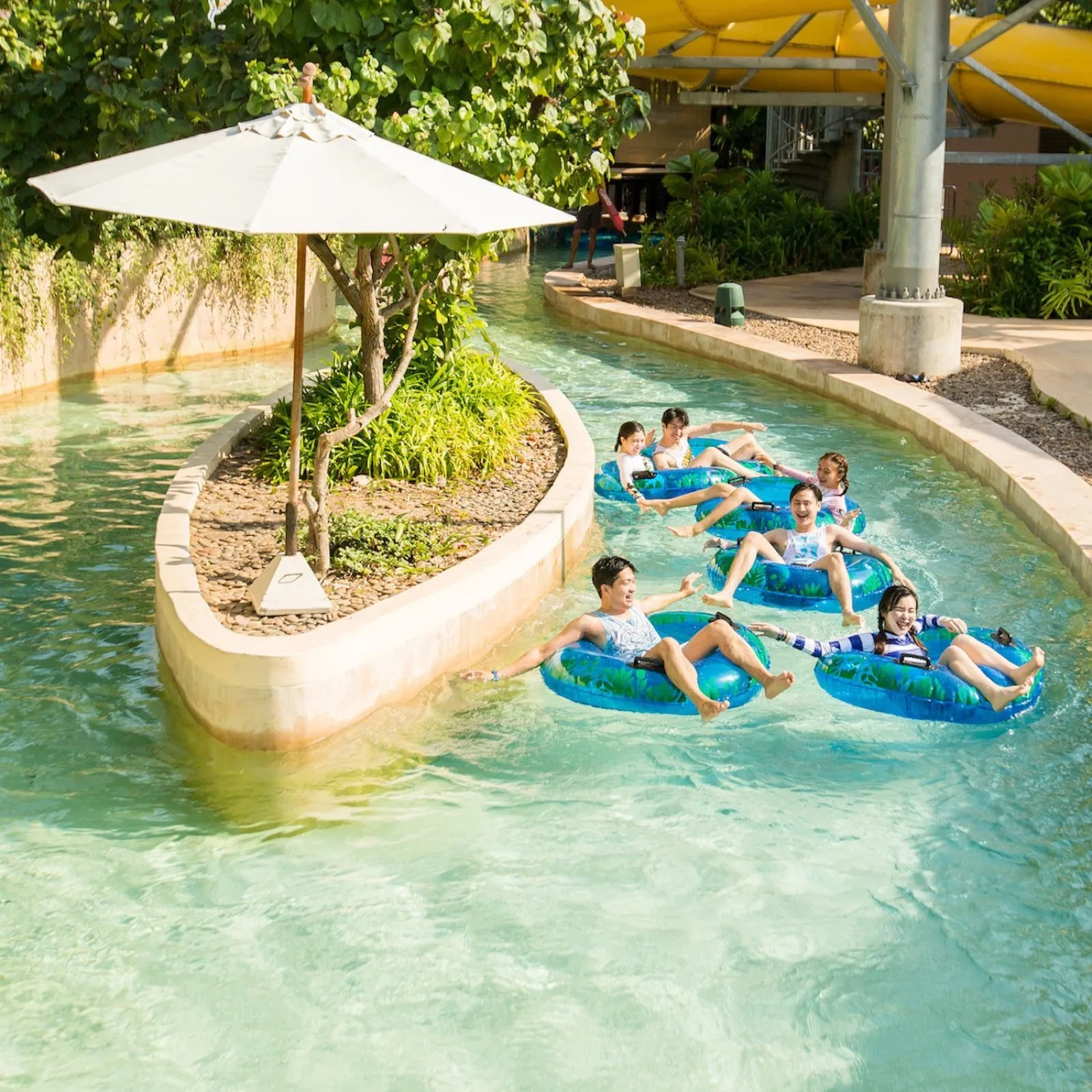Families floating in tubes along the lazy river at Vana Nava Water Jungle