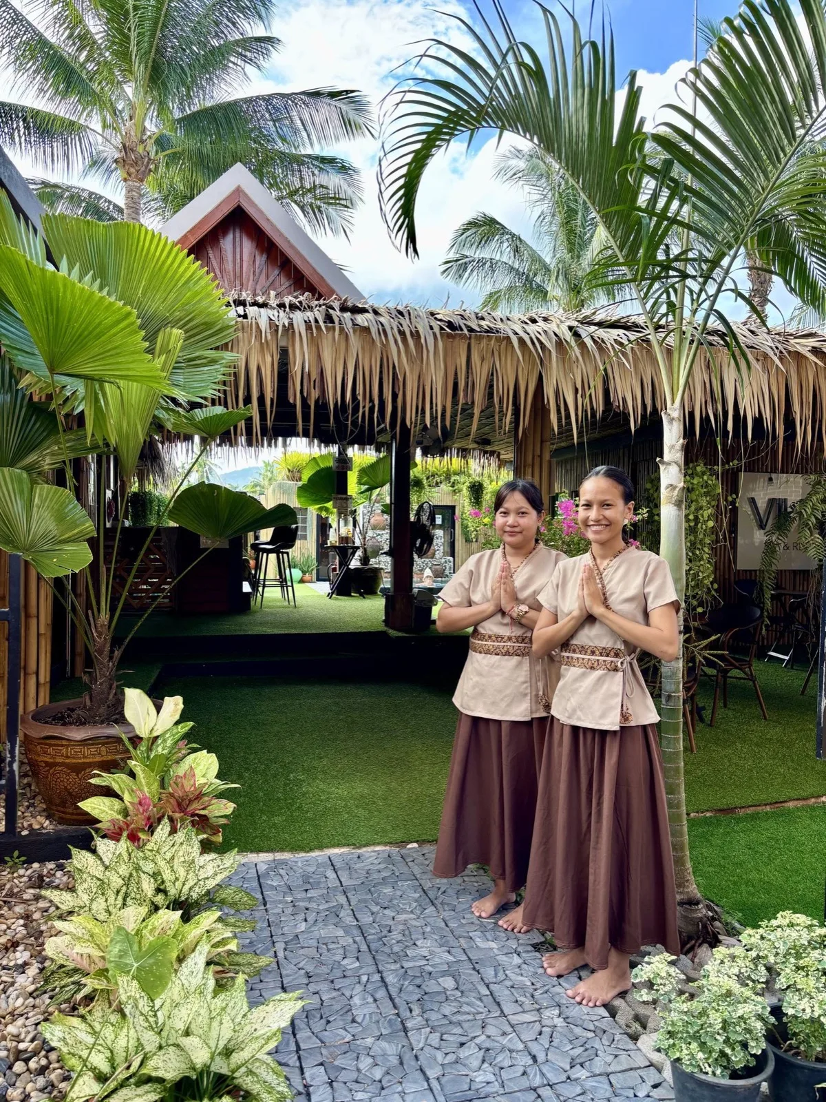 Staff welcoming guests on the garden path at Vihara Sanctuary, Lamai, Koh Samui