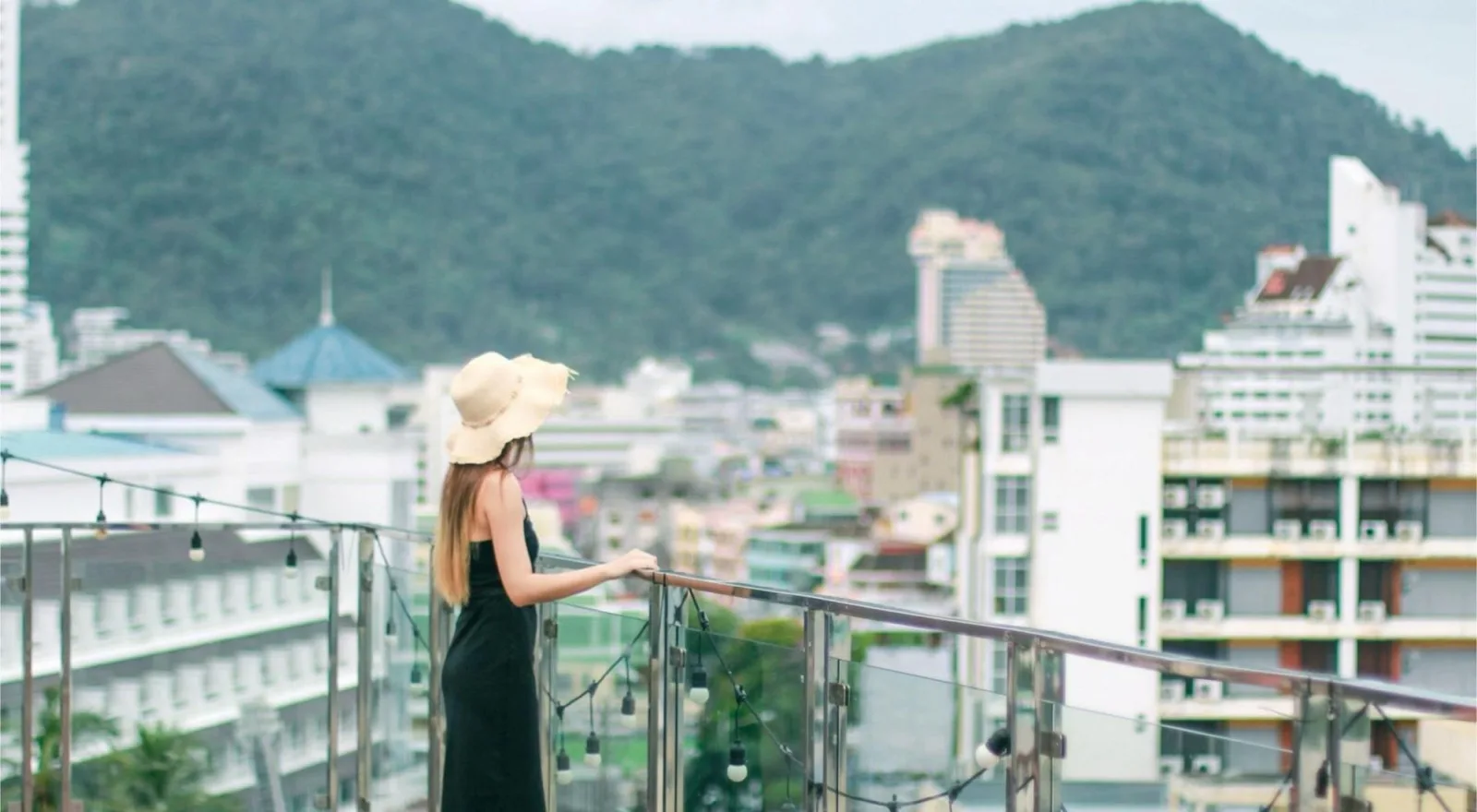 Guest admiring the panoramic Patong view from the YouDee Hotel rooftop terrace